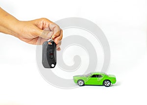 Woman holding key and automobile model on isolate white background