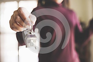 Woman holding keychains house key photo