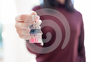 Woman holding keychains house key photo