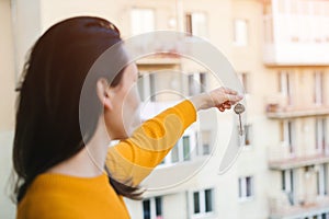 Woman holding keys to a new apartment. Real estate industry