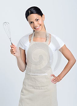 Woman holding kitchen whisk