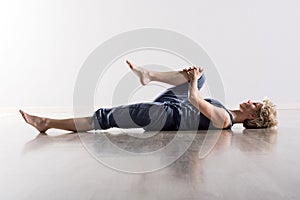 Woman holding knee while stretching hamstring