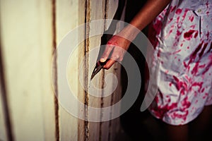 A Woman holding knife with blood, halloween concept