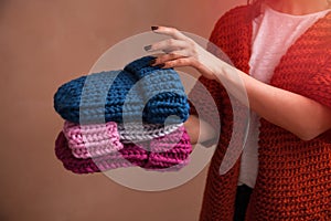 Woman holding knitted hats