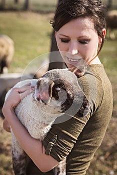 Woman holding a lamb, animal-loving and animal protection