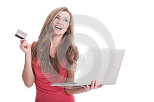 Woman holding a laptop and credit or debit card