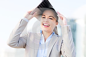 Woman holding laptop over head