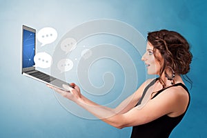 Woman holding laptop with speech bubbles