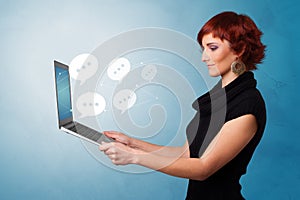 Woman holding laptop with speech bubbles