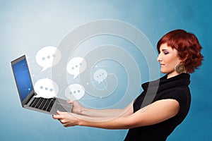 Woman holding laptop with speech bubbles