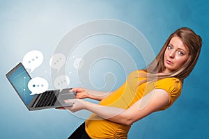 Woman holding laptop with speech bubbles
