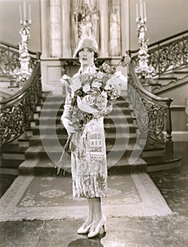 Woman holding large bouquet of flowers