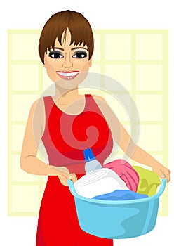 Woman holding a laundry basket full of dirty clothes