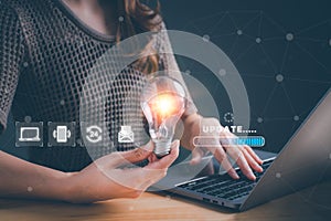 Woman holding light bulb and update software computer. Program upgrade business technology internet on virtual screen. loading bar