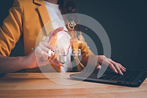 Woman holding lightbulb showing graduation hat. online education, digital courses to develop new skills, e-learning webinar on