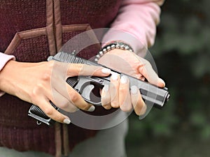 Woman holding a loaded gun