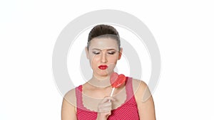 Woman holding Lollipop in the shape of heart. Valentine`s day
