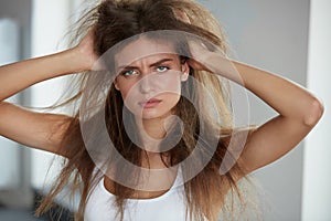 Woman With Holding Long Damaged Dry Hair. Hair Damage, Haircare.