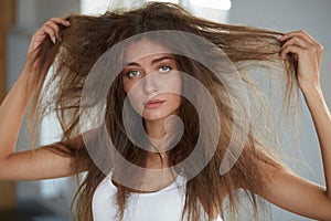 Woman With Holding Long Damaged Dry Hair. Hair Damage, Haircare.