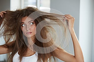 Woman With Holding Long Damaged Dry Hair. Hair Damage, Haircare. photo