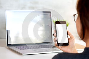 Woman holding and looking on phone mobile white screen