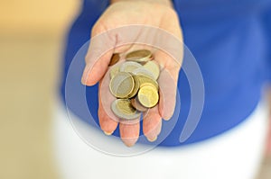 Woman holding loose change in her hand