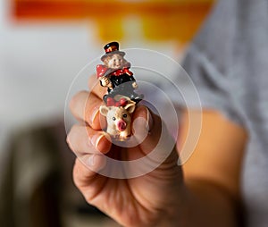 Woman is holding a lucky charm in her hand, a chimney sweep on a pig