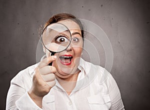 Woman holding a magnifying glass