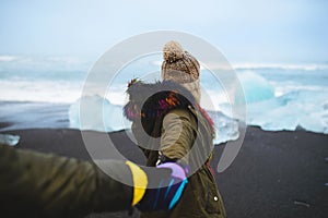 Woman Holding Man`s Hand at Sea