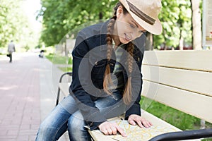 Woman holding a map in the park