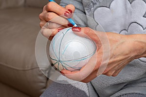Woman holding and marking stirofoam sfere for decoration photo