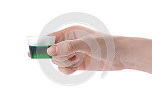 Woman holding measuring cup with syrup isolated on white, closeup. Cough and cold medicine