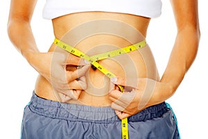 Woman holding measuring tape around waist