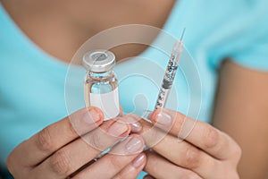 Woman Holding Medicine Bottle And Syringe
