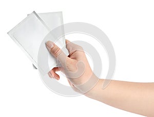 Woman holding medicine sachets on white background, closeup