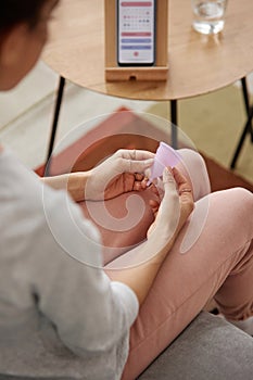 Woman Holding Menstrual Cup at Home