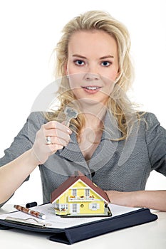 Woman holding a miniature house