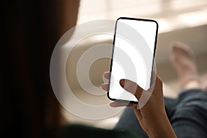 Woman holding mobile phone with empty screen, closeup