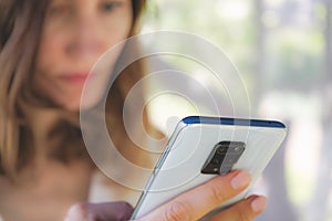 woman holding a mobile phone in her hands close-up