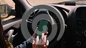 Woman holding mobile phone, smartphone in car interior