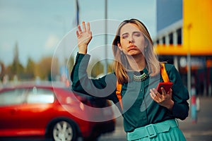 Woman Holding a Mobile Using Taxi App Waving a Car