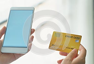 Woman holding mock up credit card  while using smartphone for shopping online by credit card.Shopping and payment online