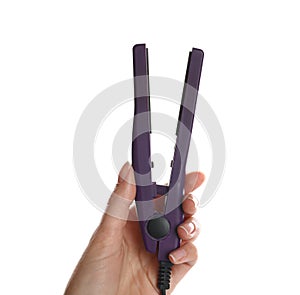 Woman holding modern hair iron on white background