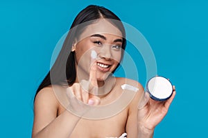 Woman holding moisture cream