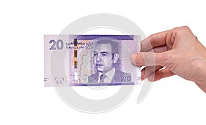 Woman holding a 20 Moroccon Dirham banknote in her hand on a white background photo