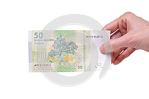 Woman holding a 50 Moroccon Dirham banknote in her hand on a white background photo