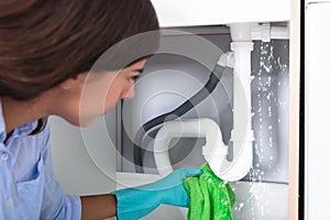 Woman Holding Napkin Under Sink Pipe Leakage