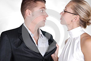 a woman holding a neckband of a man