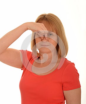 Woman holding nose