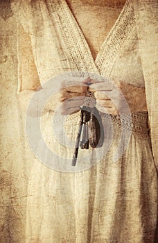 Woman holding old key in a hands